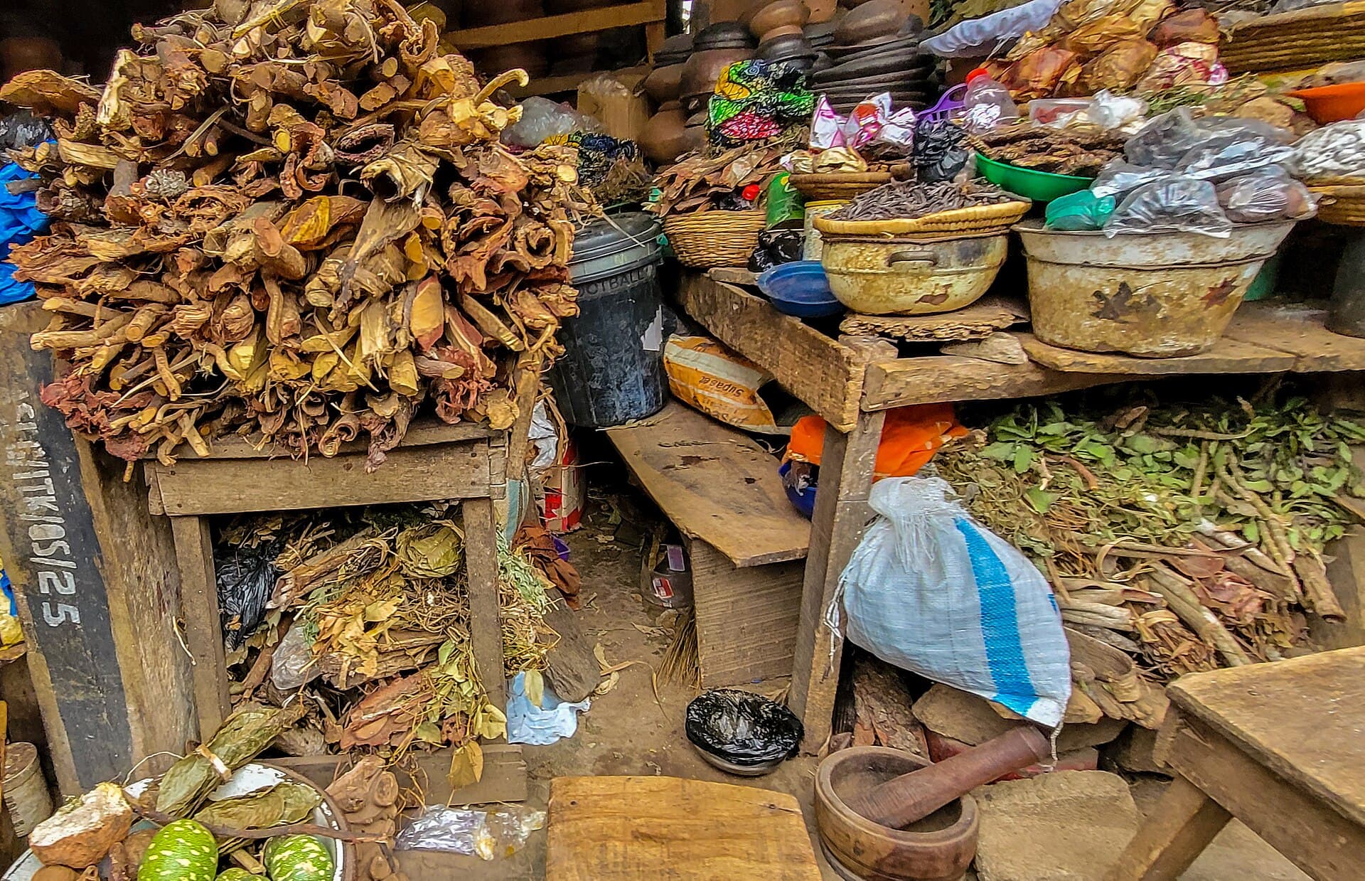 Bundles of roots and dried herbs laid out at a market stall