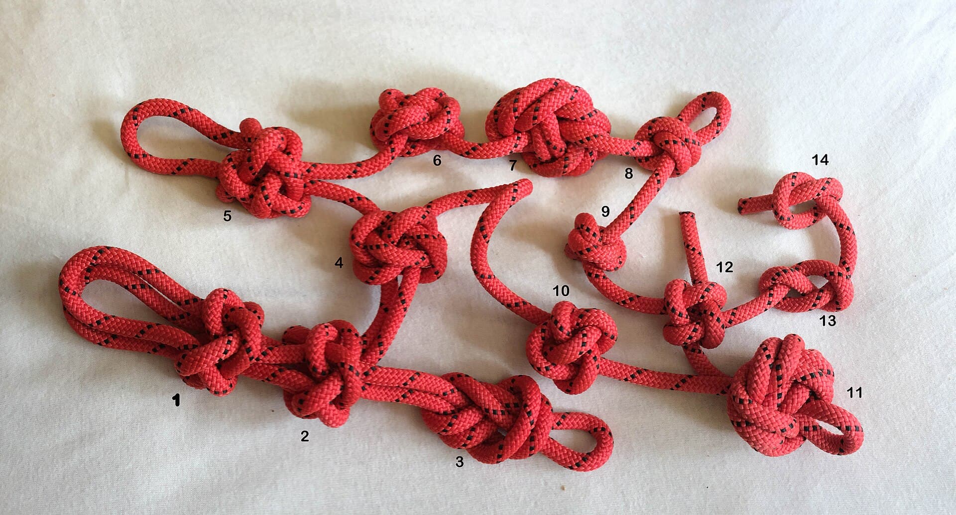 Red cord tied into a row of decorative knots