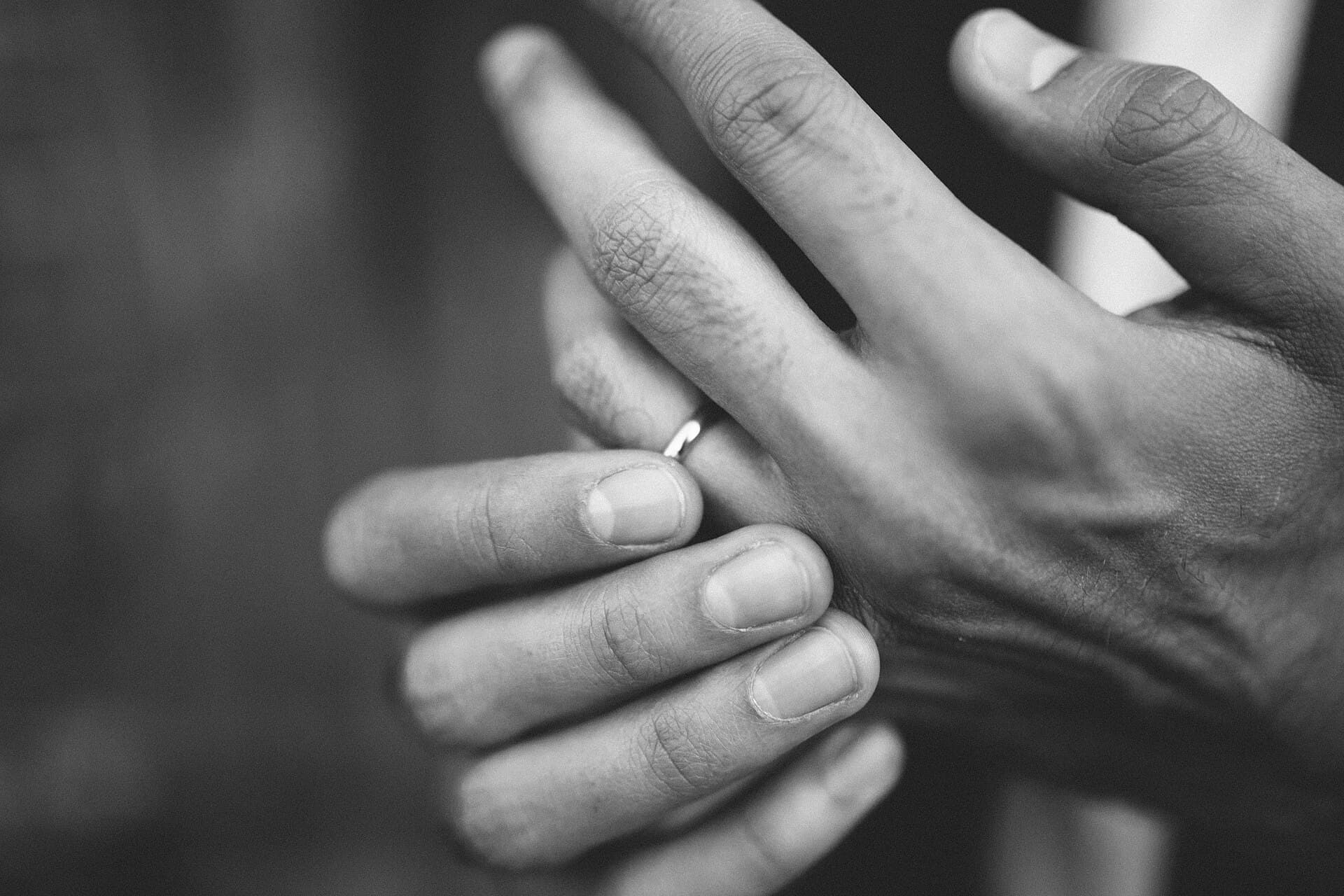 A gold wedding ring resting on a soft surface