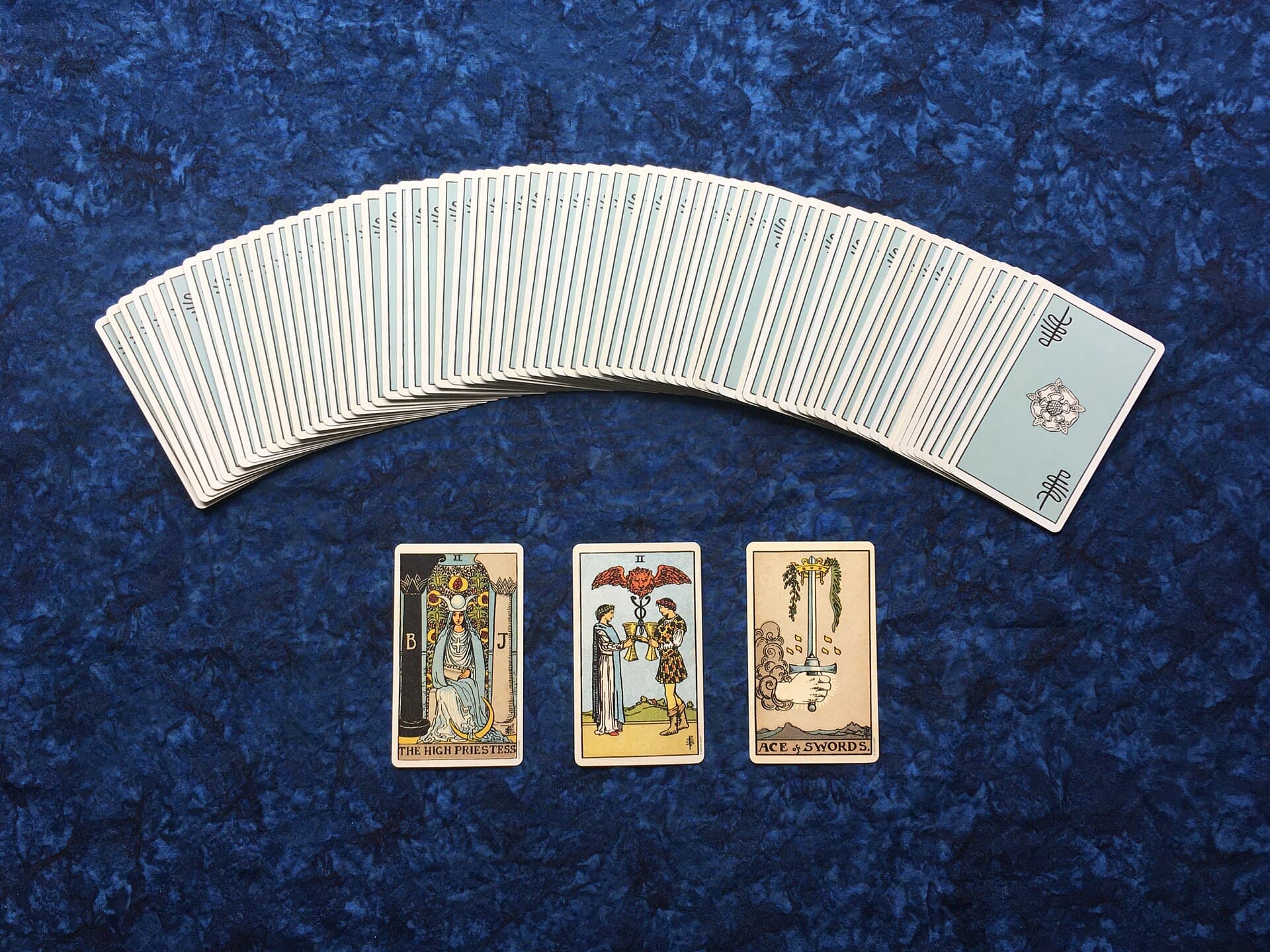 Three tarot cards laid out in a row for a three-card spread